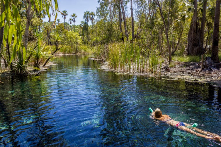 woman swims in springs