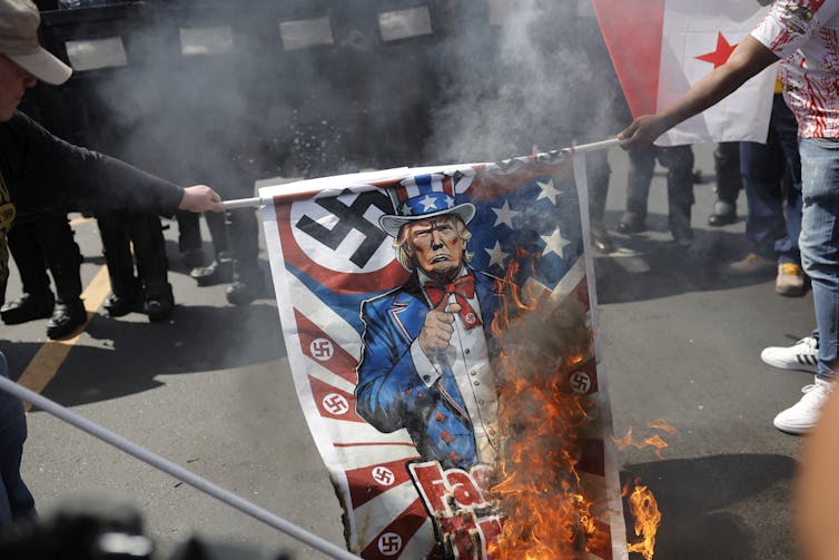 US power has pressured Panama to surrender China’s Belt and Highway Initiative – it would set the trend for additional superpower clashes 1 A US flag festooned with swastikas and with a picture of Donald Trump is burned by protesters in Panama City.