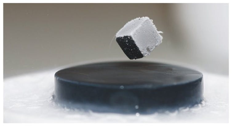Superconductor levitates a magnet.
