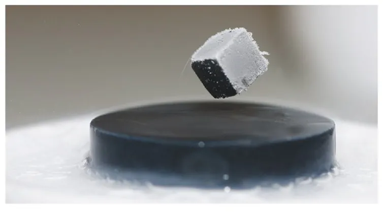 Superconductor levitates a magnet.