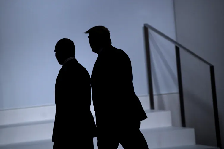 The shadows of two men is seen.