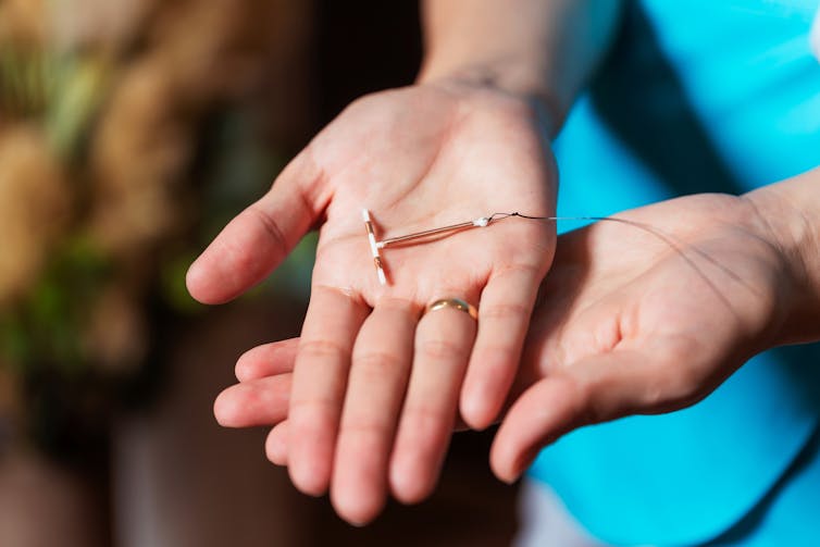 Clinician holds an IUD.