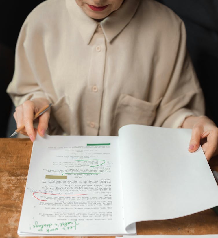woman marking up manuscript