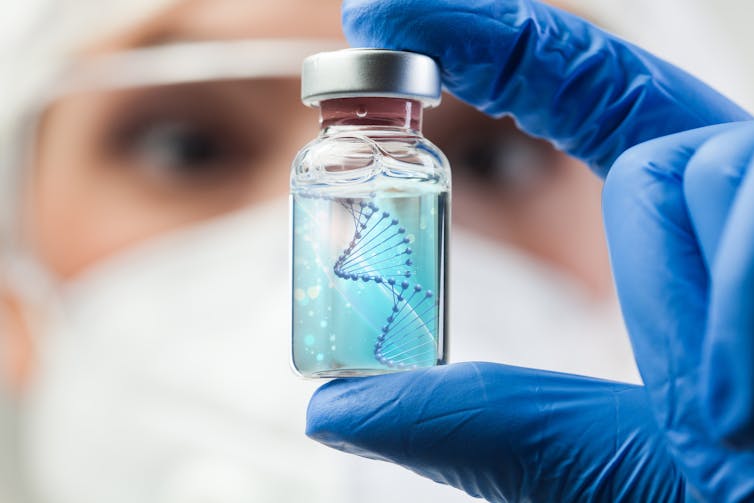 A researcher holds a vial containing DNA