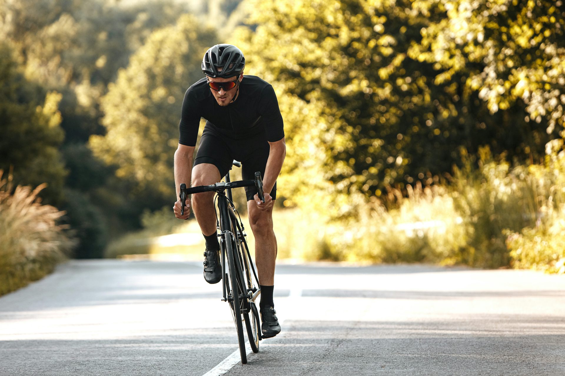 A man riding a bike along a road.