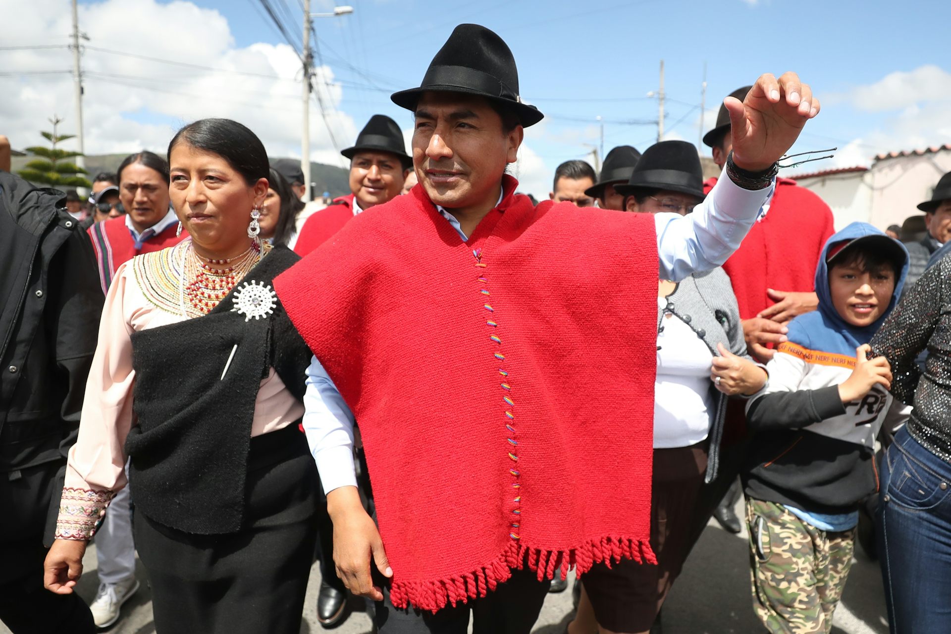 Leonidas Iza dressed in red arriving at a polling station to cast his vote.
