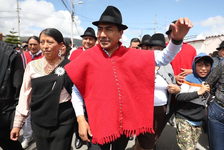 Ecuador election heads to runoff – Indigenous motion now holds key to the result 1 Leonidas Iza dressed in red arriving at a polling station to cast his vote.