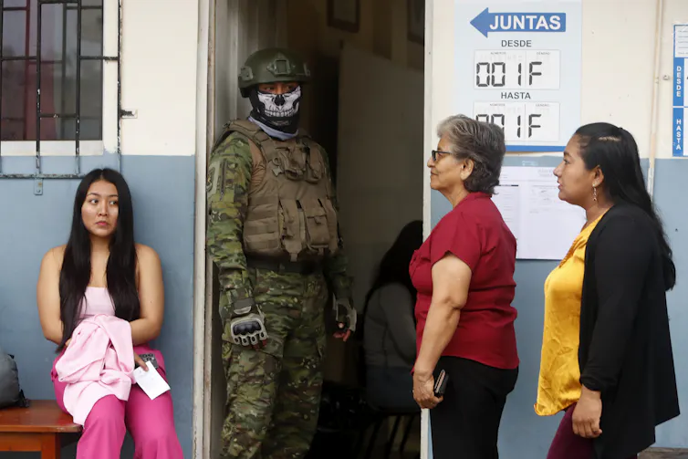 A guard outside a polling station in Ecuador.