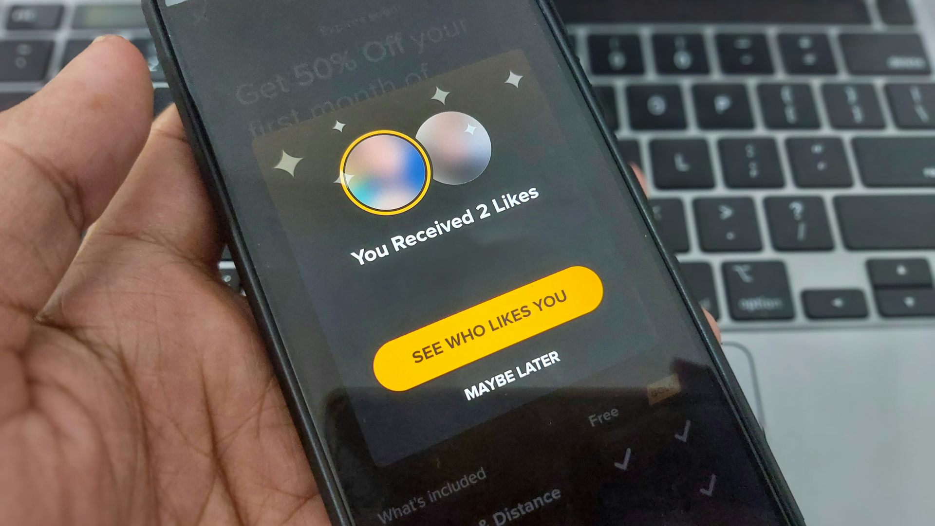 man holding phone with dating app opened