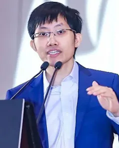 Man in suit speaking at a conference