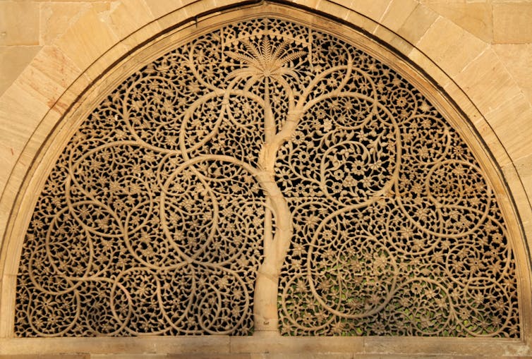 Tree carved into a stone window screen