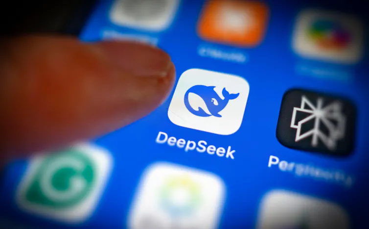 Finger held over smartphone showing DeepSeek logo.