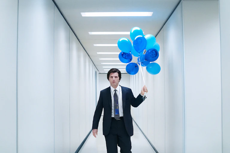 Picture of lead actor in Severance walking in hallway with balloons
