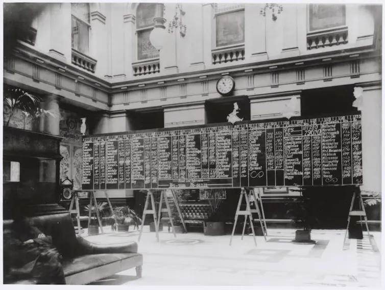 A large blackboard with a series of numbers being tallied up.