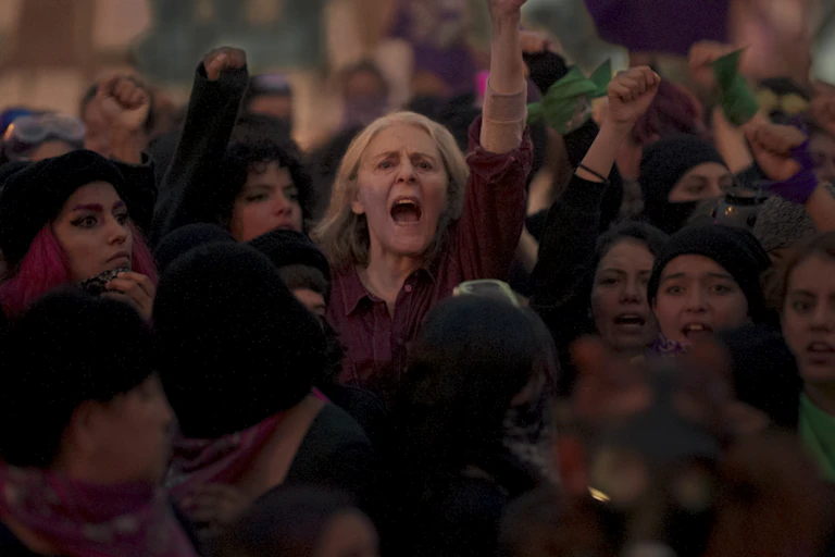 A woman stands proud in a protest.