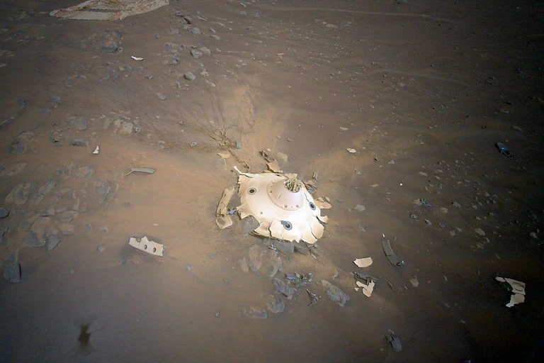 Scattered white metal among brown dust.