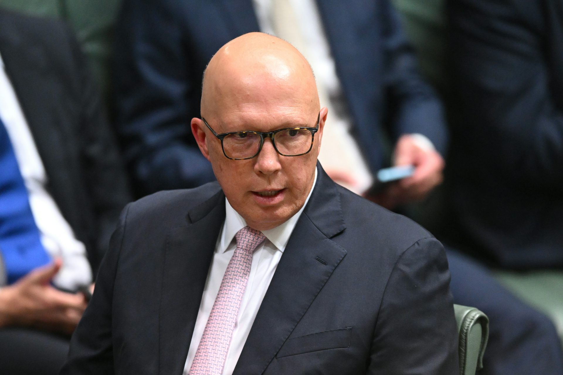 Opposition Leader Peter Dutton sits in a chair in the House of Representatives.