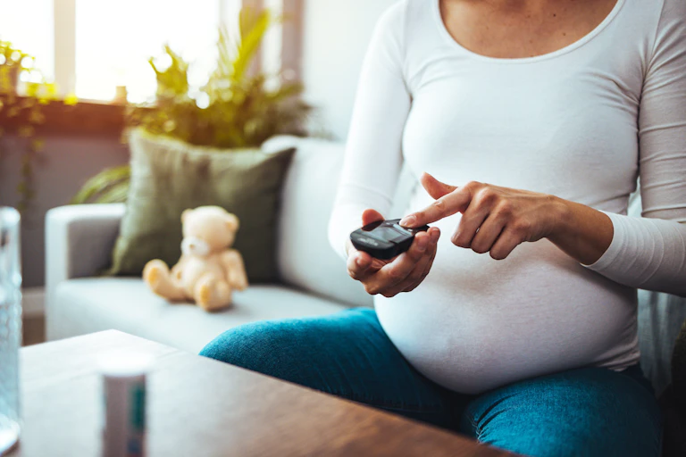 A pregnant woman checking her blood sugar levels