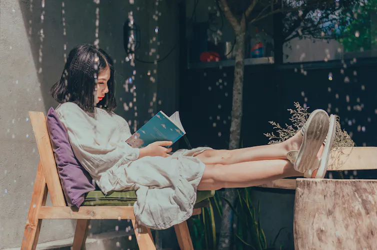 Woman on chair reading book