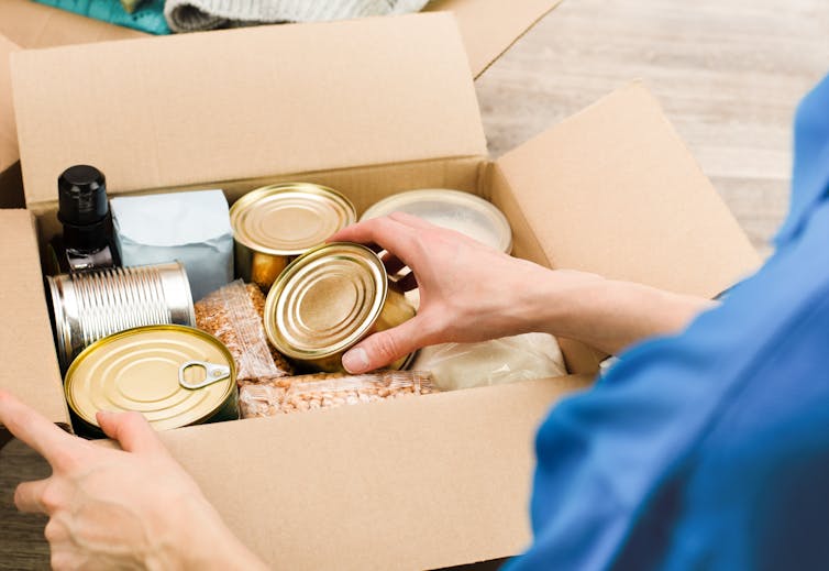 Hand pacing can of food into box