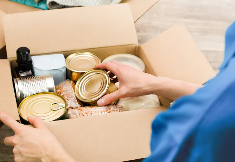 Hand pacing can of food into box