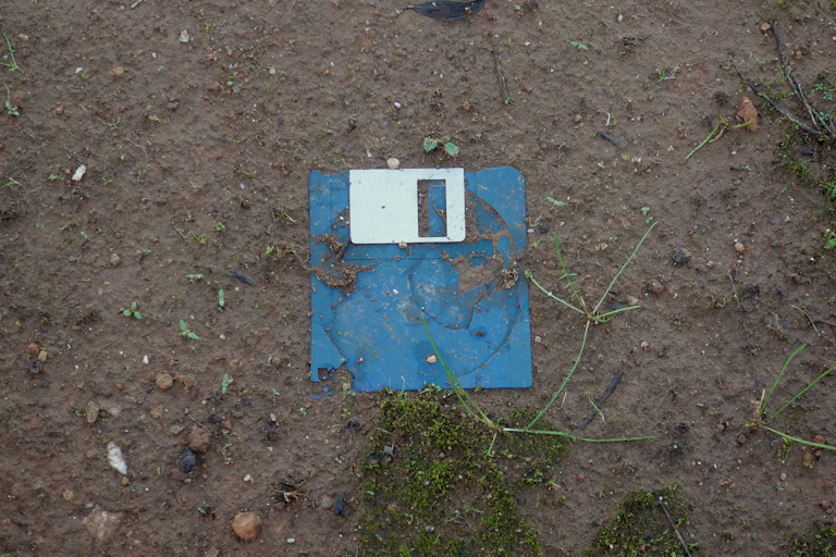 Old floppy disk in soil