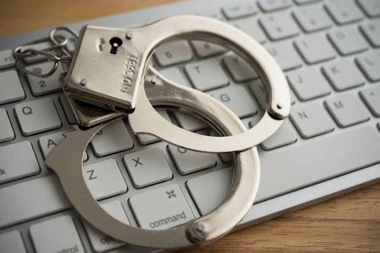 Handcuffs on a computer keyboard