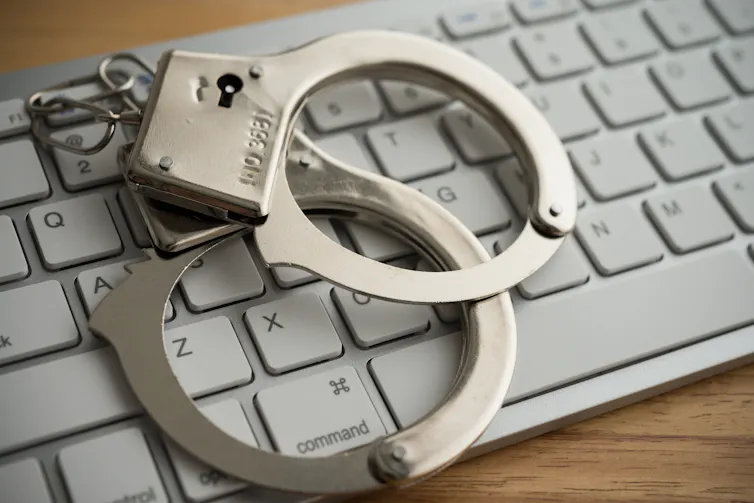 Handcuffs on a computer keyboard