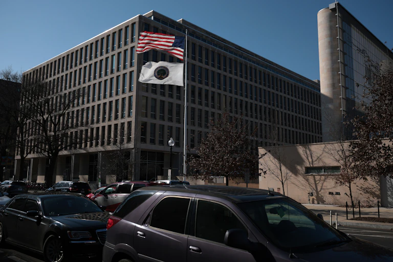 Cars and flags appear in front of an office building.