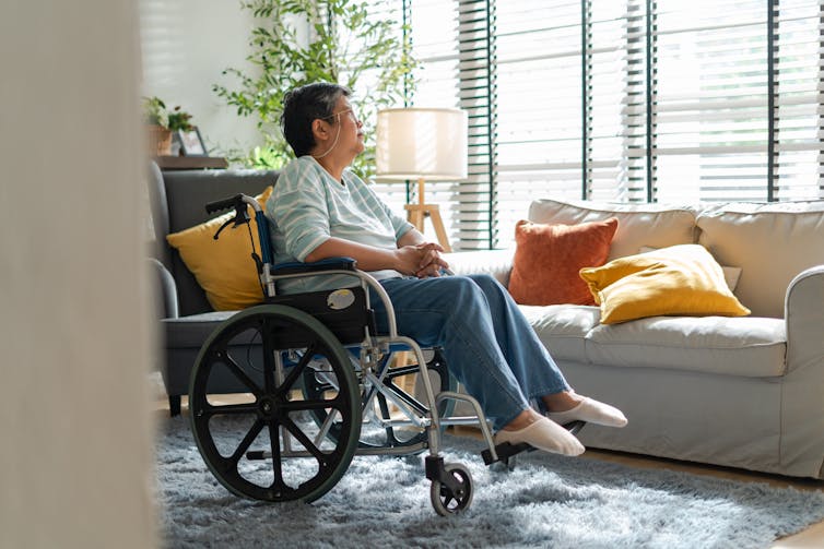 A senior woman sitting in a wheelchair.