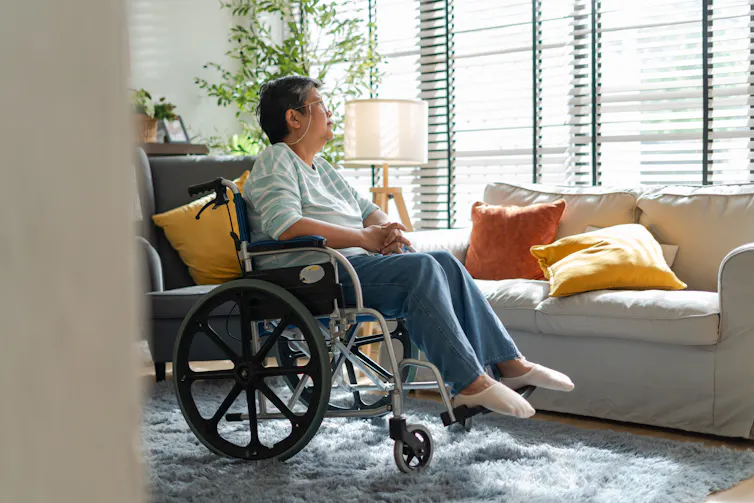 A senior woman sitting in a wheelchair.