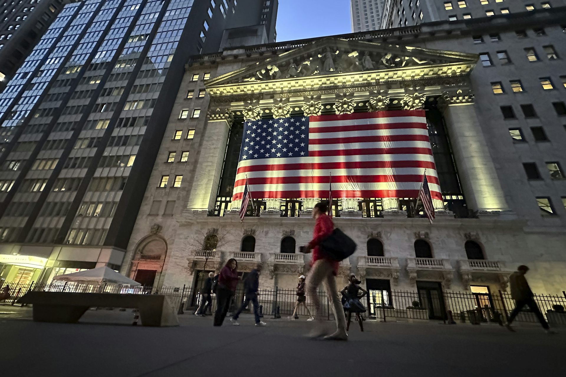 People walk past the New York Stock Exchange