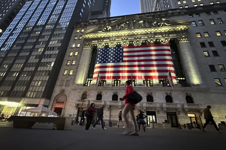 People walk past the New York Stock Exchange