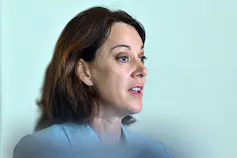 Profile of a dark haired woman who is speaking