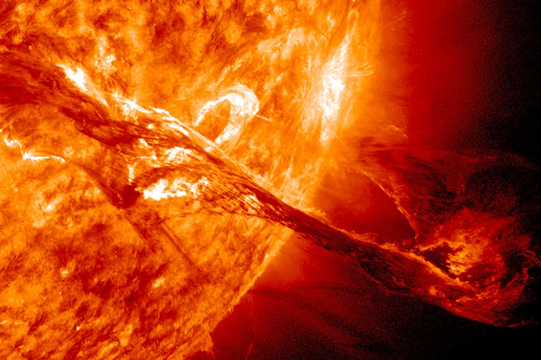 An illustration of a thread of energy moving out into space from the surface of the Sun.