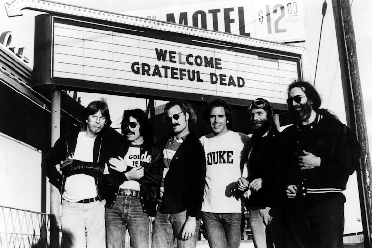 Grateful Dead, six men standing outside of a gig venue.