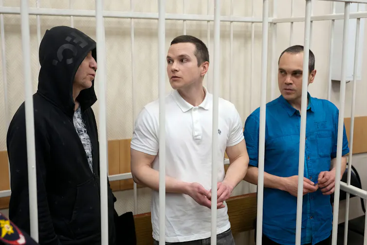 Three men behind bars in a Russian jail