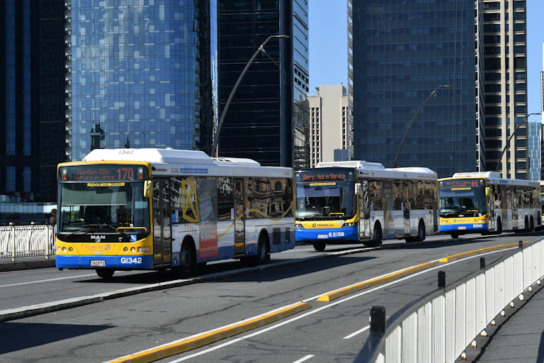 A line of Brisbane City Council Buses are seen driving across the Victoria Bridge in Brisbane
