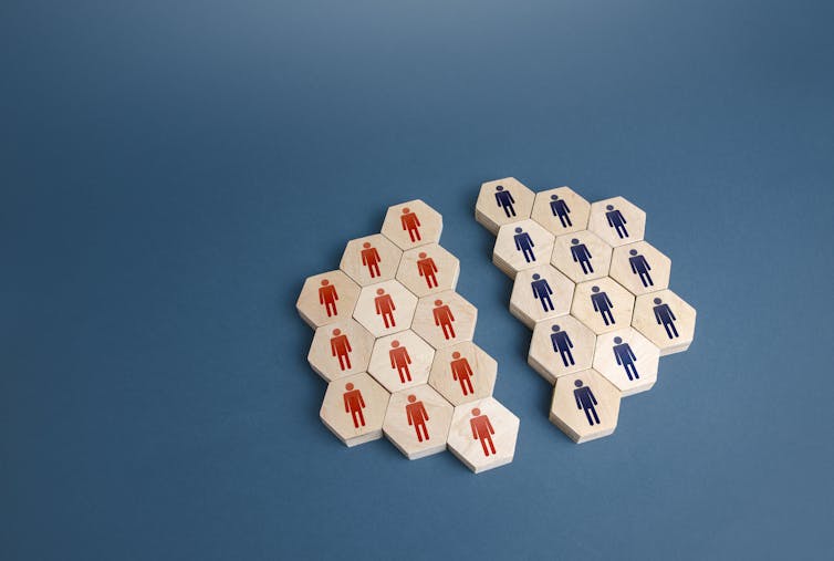 Photo of tiles with pictures of people on them, arranged into two groups by colour.