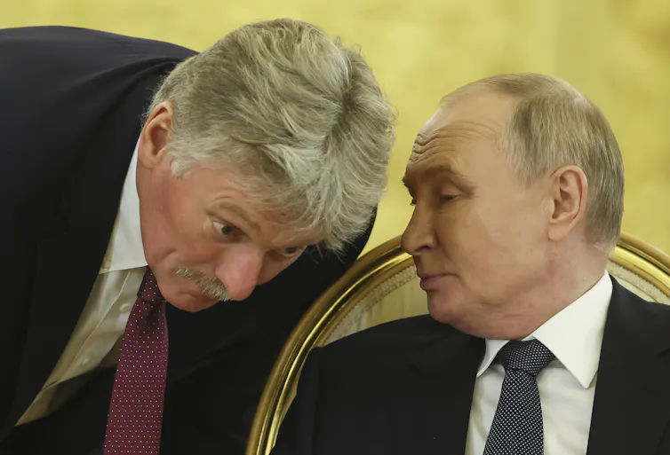 Russian president Vladimir Putin speaks to Kremlin spokesman Dmitry Peskov