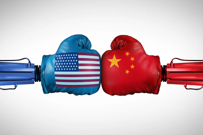 Robotic arms with US and China flags on their gloves.