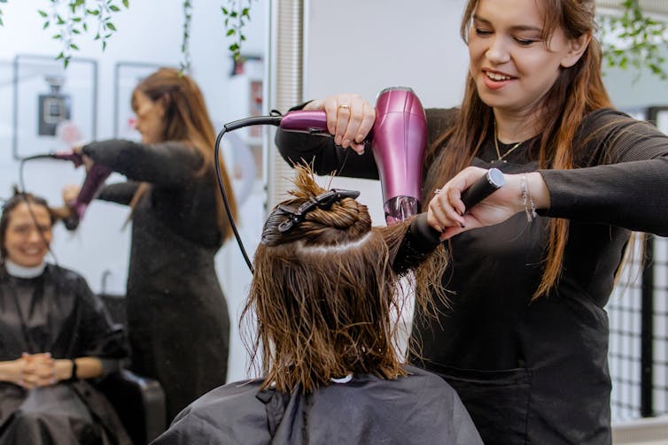 professional hairdresser hair styling client in beauty salon