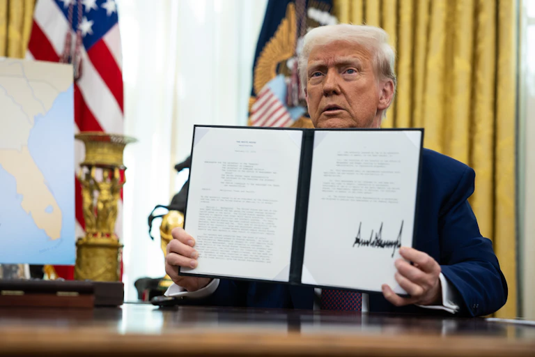 Trump sat in the Oval Office after signing an executive order.