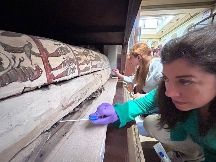 Cecilia Bembibre opening a sarcophagus.