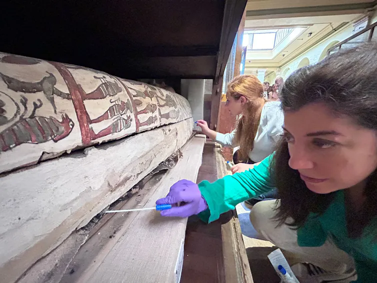 Cecilia Bembibre opening a sarcophagus.