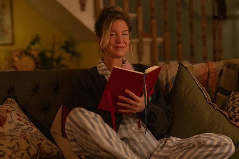 Bridget Jones on her sofa with her diary.