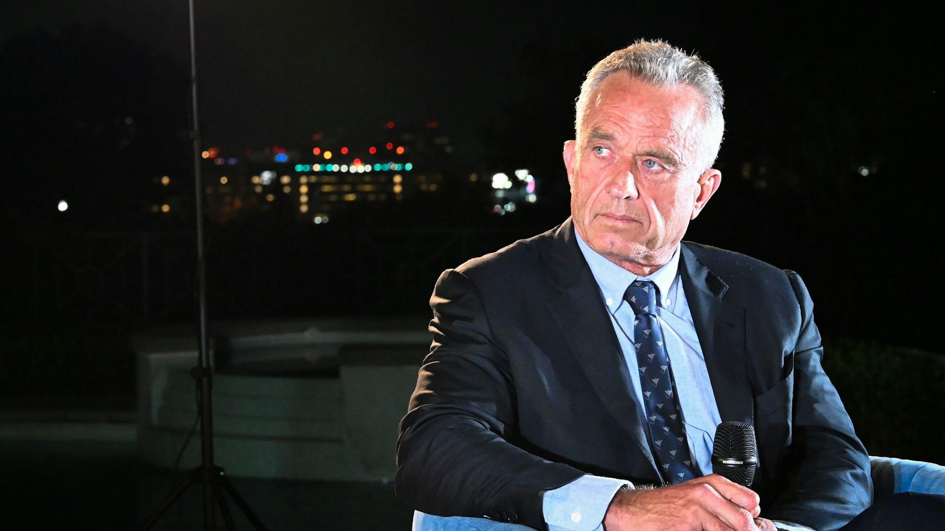 RFK Jr. on a stage in front of a mic.