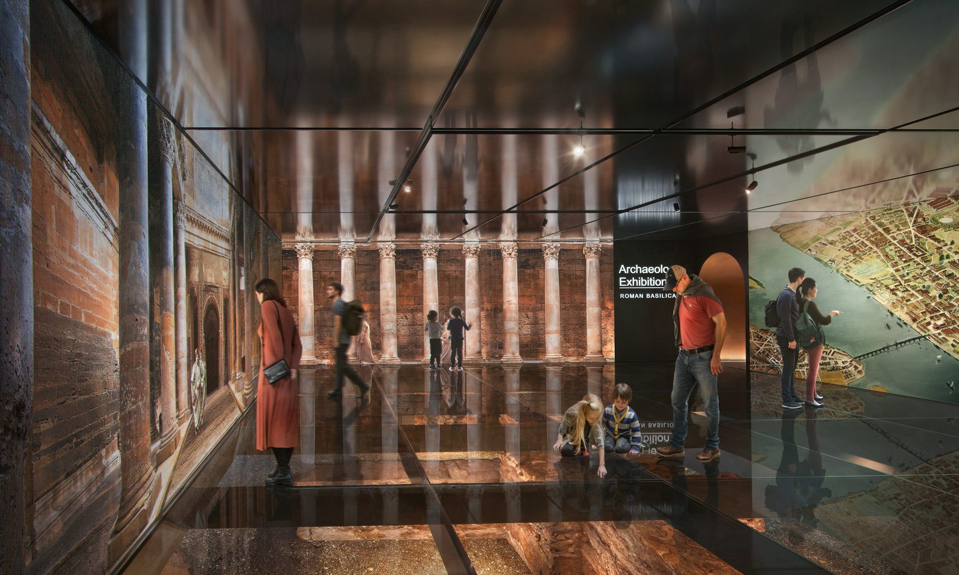 An exhibition space with people looking at replica Roman walls