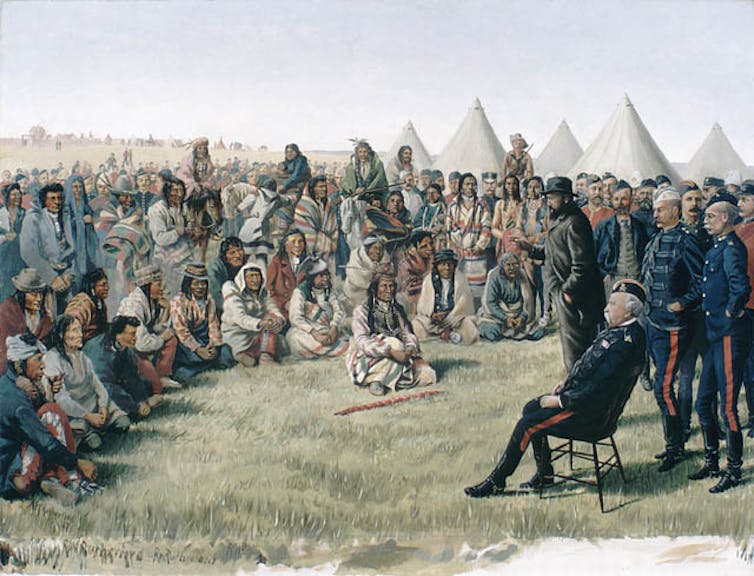 Painting of a group of people in a circle, some seated and some standing, in front of a seated soldier in uniform.
