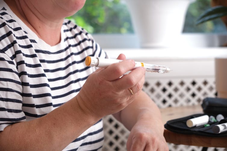 person preparing their insulin